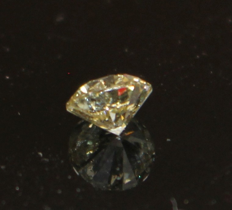 An unmounted round brilliant cut diamond, weighing 1.02ct, with an estimated colour and clarity of S/T/U? and I3.